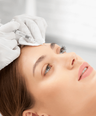 Attractive woman receiving skin rejuvenation treatment on forehead